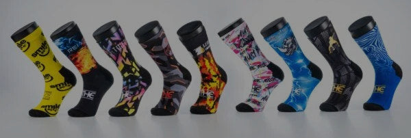 Row of colorful socks with various patterns on a white background